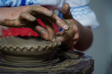 Pottery. The oldest trade from Daco-Roman times. Hands dirty with clay. Ceramics. Modeling in clay. Color and black-and-white detail photos.