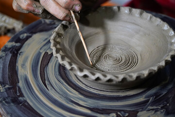 Pottery. The oldest trade from Daco-Roman times. Hands dirty with clay. Ceramics. Modeling in clay. Color and black-and-white detail photos.