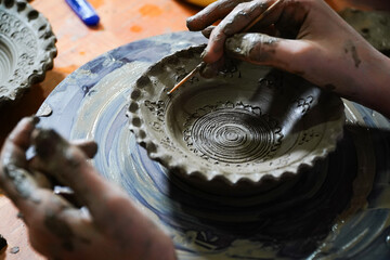 Pottery. The oldest trade from Daco-Roman times. Hands dirty with clay. Ceramics. Modeling in clay. Color and black-and-white detail photos.