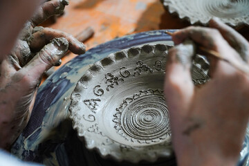 Pottery. The oldest trade from Daco-Roman times. Hands dirty with clay. Ceramics. Modeling in clay. Color and black-and-white detail photos.