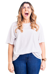 Young caucasian woman wearing casual clothes angry and mad screaming frustrated and furious, shouting with anger. rage and aggressive concept.