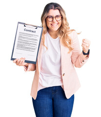 Young caucasian woman holding clipboard with contract document screaming proud, celebrating victory...