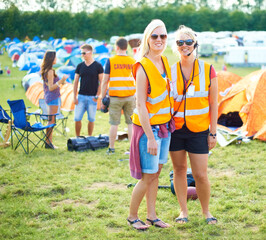 Portrait, sunglasses and event staff at festival for music, party and carnival outdoor in summer....
