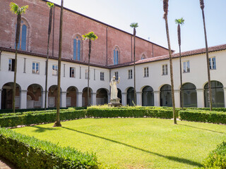 The interior of the Cloister of the Church of San Francesco with the statue of the Saint, in Lucca, Italy