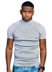 Fototapeta premium Young black man wearing casual t shirt depressed and worry for distress, crying angry and afraid. sad expression.