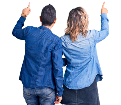 Couple of women wearing casual clothes posing backwards pointing ahead with finger hand