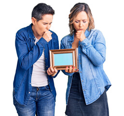 Couple of women holding empty frame feeling unwell and coughing as symptom for cold or bronchitis. health care concept.