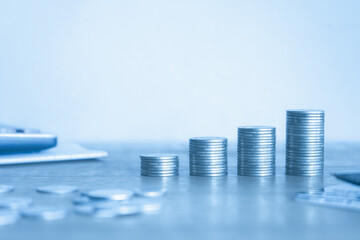 Stack of money con on blue background. Business and financial concept. 