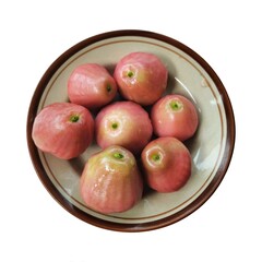 Red rose apple fruit on a plate isolated on white background. Top view.