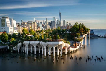 Muurstickers View of downtown Manhattan with the Little Island public elevated park in the foreground. New York City cityscape before the sunset. © VOJTa Herout