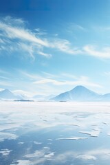 Snowy landscape photography with a serene frozen lake and distant mountains, captured on a clear January day