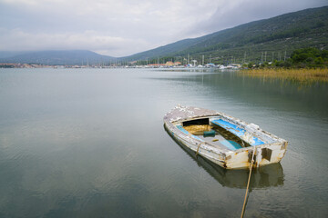 Fototapeta na wymiar Small shabby boat in a bay of Cres