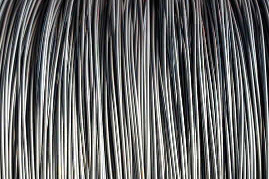 Pile of iron, metal or steel wire rod or coil background for Construction industry. steel wire fence rolls. Steel wire tie rolls for construction and industrial. Coil of iron or steel background.