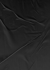 Background texture of crumpled thin black paper