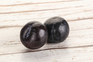 Two ripe sweet black plums