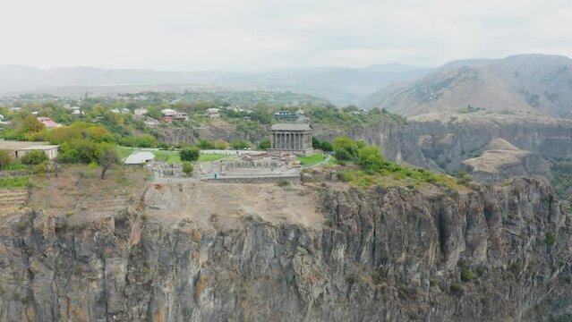   The hellenistic temple Garni in Republic of Armenia. Drone view building on rock. Aerial footage antique, old temple Garni in Armenia. The historic Greek style building. 