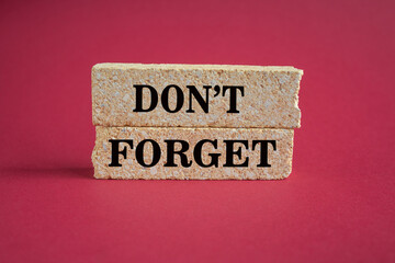 Do not forget symbol. Concept word Don't forget on brick blocks. Beautiful red background. Business...