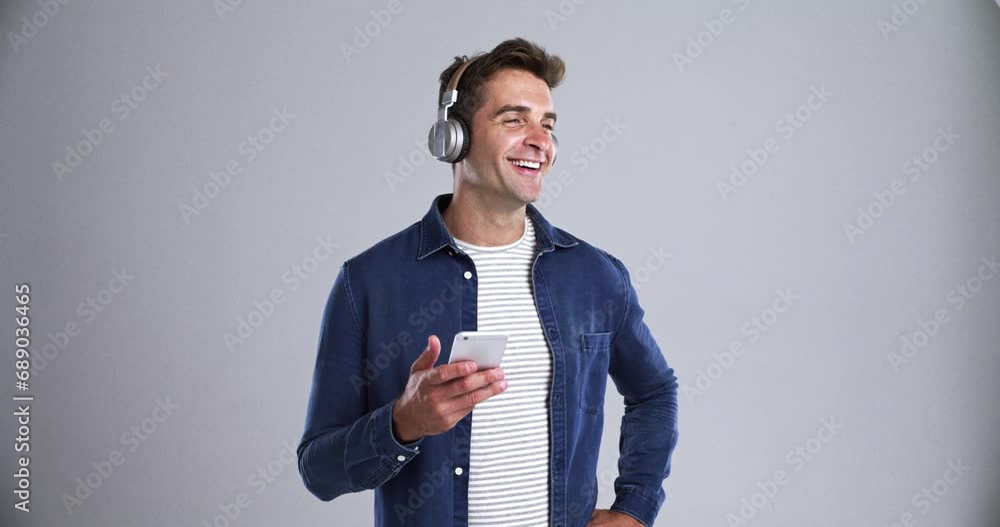 Poster Man, headphones and phone call for networking, communication and connection in studio by grey background. Male person, smartphone and conversation or telemarketing for startup, smile and discussion