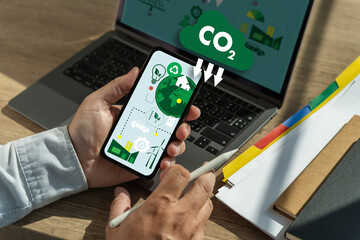 Businessman working computer to reduce CO2 depicting the issue of carbon dioxide Net zero and carbon neutral concept - obrazy, fototapety, plakaty