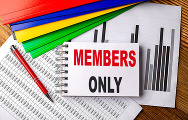 MEMBERS ONLY text on a notebook with pen, folder on a chart background