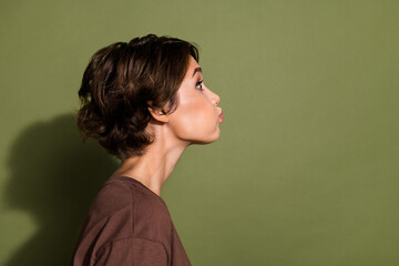 Side profile photo of funny funky girl dressed brown t-shirt hold breath staring at empty space...
