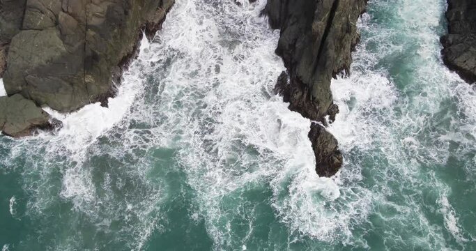 4k drone birds eye view above waves crashing on rocks cliffs brookings oregon coast