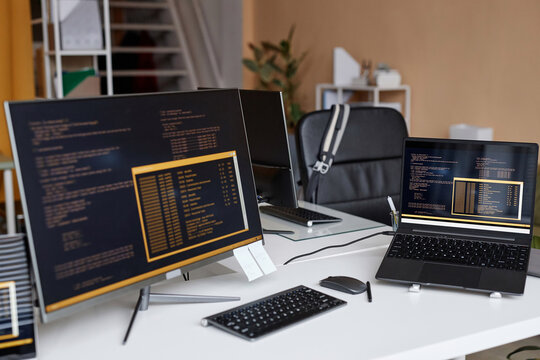 Background image of multiple computer devices with code lines on screen in IT development office, copy space