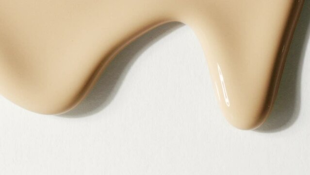 Foundation  makeup smear, concealer, cosmetic liquid foundation, or cream beige color smudge flowing down