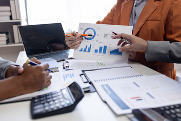 Close up Team of colleagues discussing business Accounting using calculating income-expenditure and calculator analyzing real estate investment data report Financial and tax systems concept.