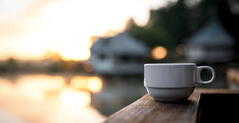 Hot coffee cup  on the wooden table and the blurred background with copy space for your text