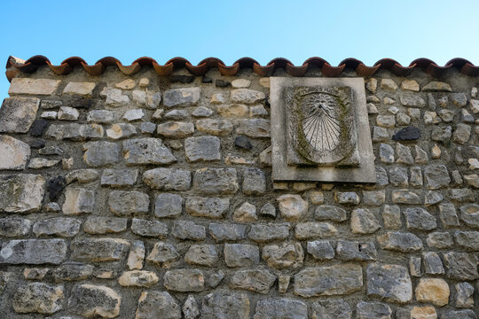 A  sundial on the wall at the ancient village Rochemore, France (Ardeche). Latin phrase Tempus fugit is translated into English as time flies.