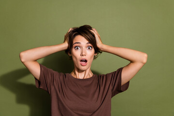 Photo portrait of lovely young lady touch head astonished frightened dressed stylish brown garment isolated on khaki color background