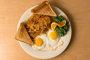 fried eggs, toast and hash browns