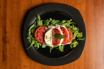 Tomato and mozzarella salad on a arugula