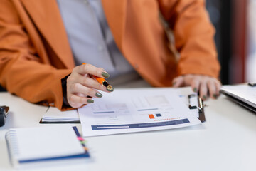 Business woman working at office with documents on his desk, doing planning analyzing the financial report, business plan investment, finance analysis concept	