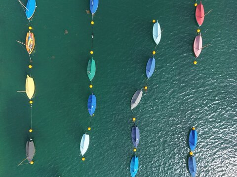 .Colourful sailing dinghy&rsquo;s moored Fowey Cornwall UK Overhead birds eye drone aerial view