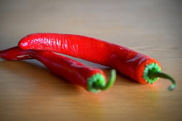 High resolution Isolated close up macro image of a couple of fresh red hot chili peppers 