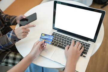 Woman shopping on laptop holding credit card for Internet online e-commerce shopping spending money Online shopping Mobile phone laptop technology concept