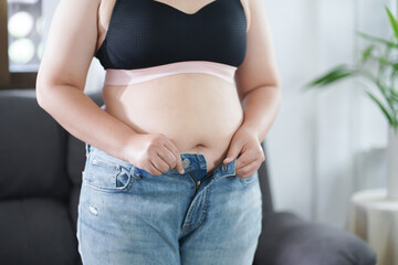 Obese Woman with fat upset about her belly. Overweight woman touching his fat belly and want to...