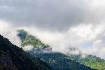 travel to Georgia - gray clouds lie on tops of mountains in Machakhela national park in Adjara on autumn day