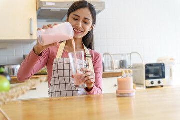 Asian woman making healthy drinking fresh  homemade  in home kitchen counter - obrazy, fototapety, plakaty