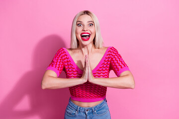 Portrait of astonished lovely person open mouth arms palms touch plead isolated on pink color...
