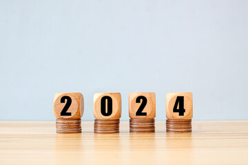 Cube wood New years 2024 start up investment new business and finance economy growth row of coins.Saving money and financial plan concept for investment in new year 2024. - Powered by Adobe