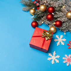 Gift in red box for Christmas and New Year, top view, blue background