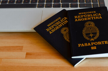 Argentine passport on notebook taking out tickets to travel
