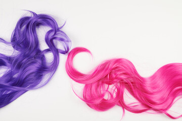 Natural looking shiny hair of different bright colors, cosplay wig on a white background