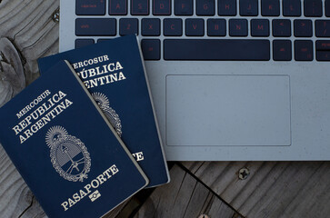 Argentine passport with PC in the background taking out airfare. document to leave the country for...