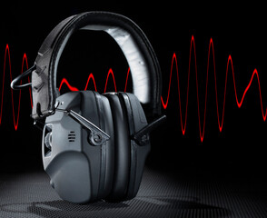 Red sine wave behind electronic hearing protection ideal for construction, manufacturing to...
