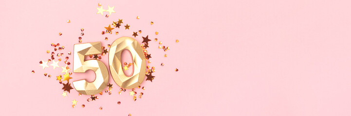 Banner with golden number 50 and stars confetti on a pink background. Concept with copy space.