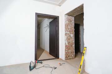 Installing door at construction site in an empty room